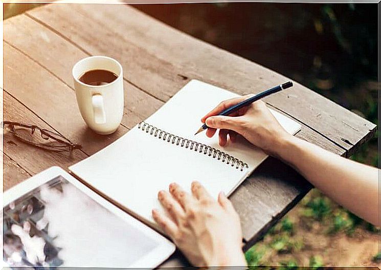 Person writing outdoors.