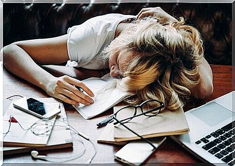 Tired woman with her head on the desk