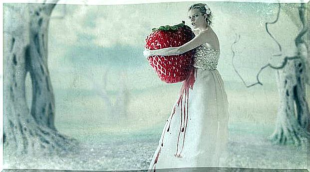 Woman with big strawberry