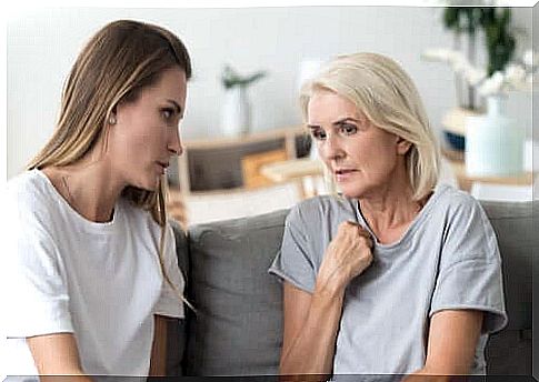 Woman talking on sofa.