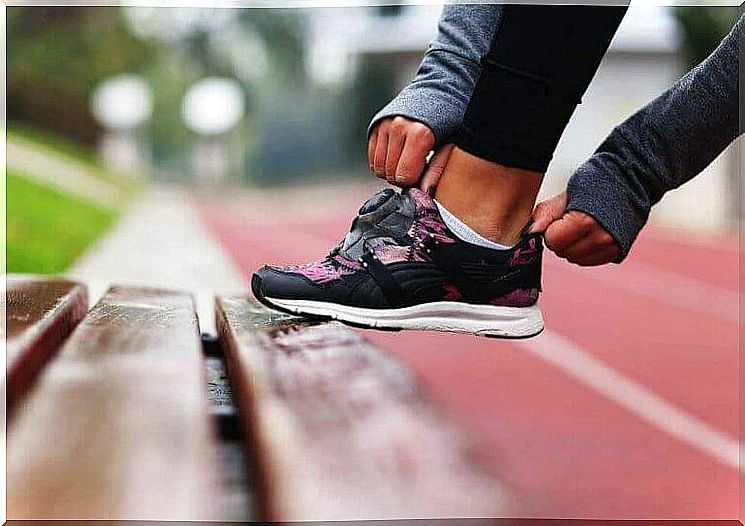 Woman fixing her shoe.