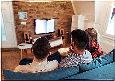 Three friends looking at a screen.