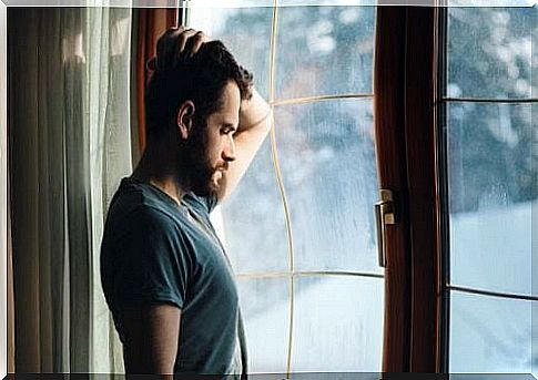 Depressed man by window