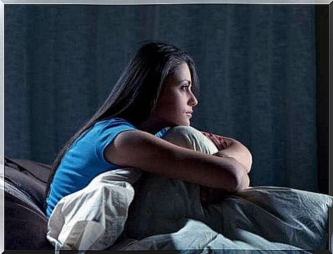 Woman with sleep problems sitting in bed