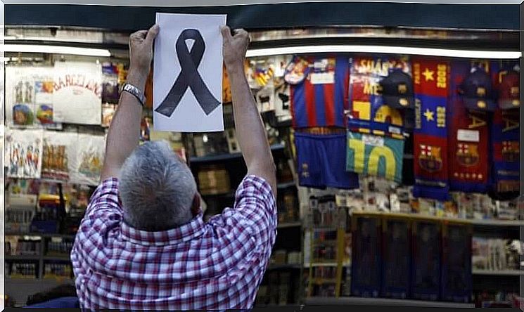 Man hanging up black ribbon after terrorist attack in Barcelona