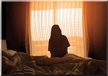 A woman looking out of her bedroom window