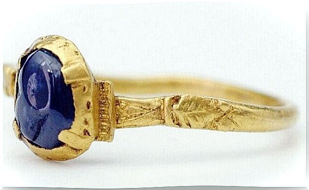 Gold ring with blue stone.