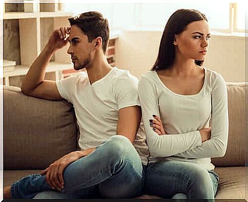 Woman and man sitting on sofa.