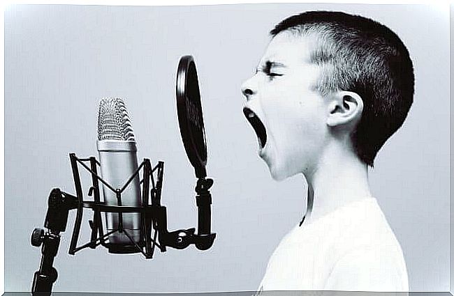 Boy talking into microphone.